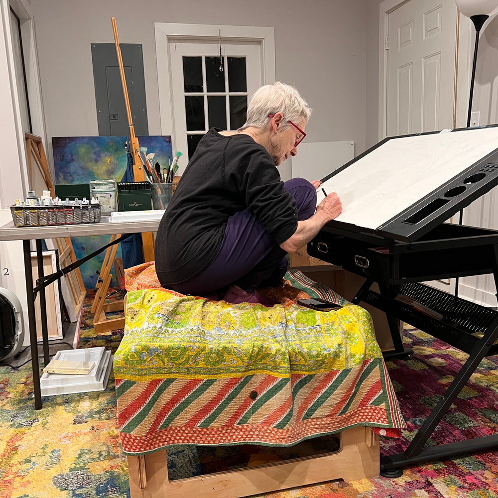 
                      
                        Artist painting while actively sitting on higher ground chair
                      
                    